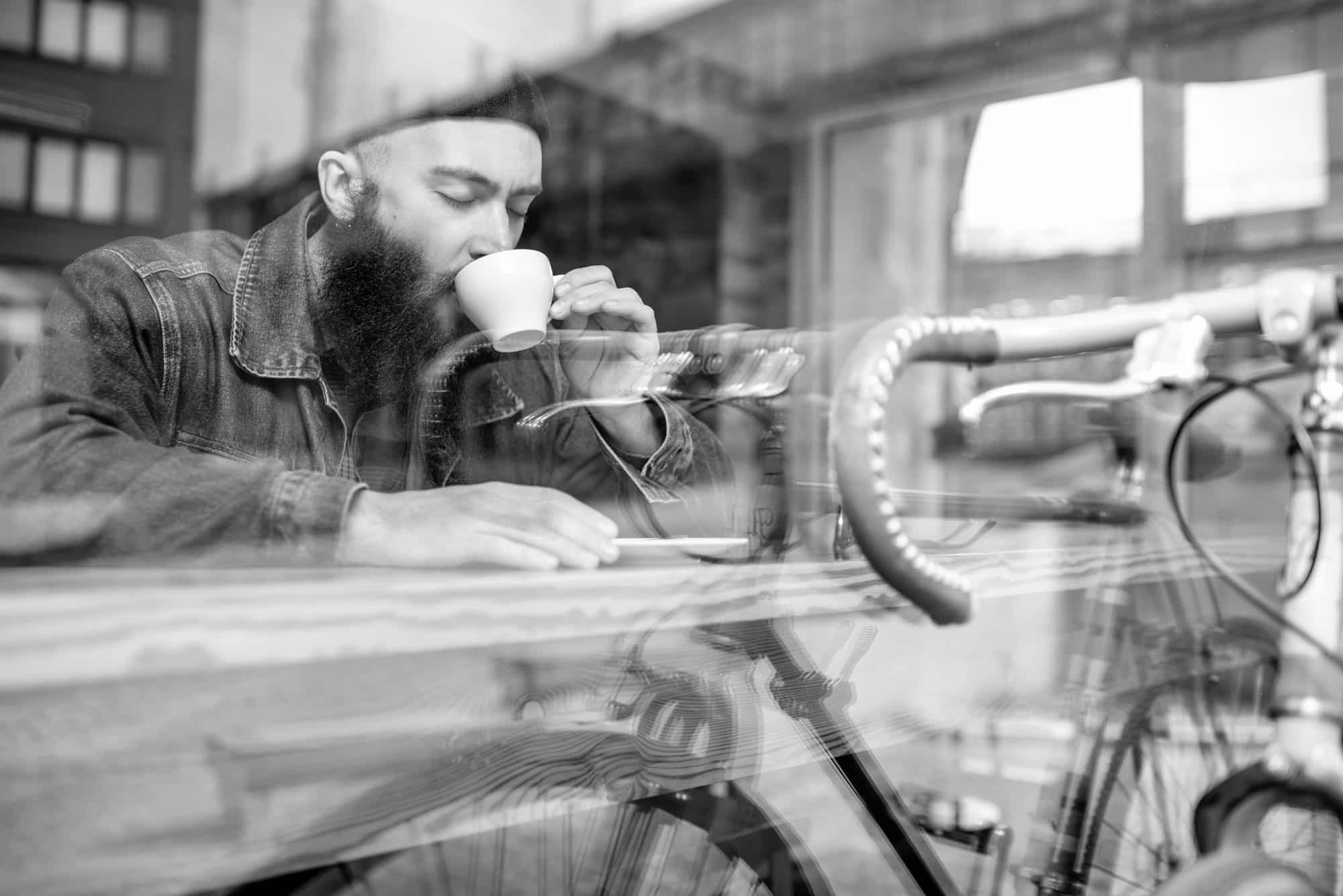 Person drinking coffee - bike - hipster - reused coffee grounds - reuse - recycle - sustainable - circular economy - circulatte - coffinery - zero waste - coffee based biorefinery - coffee waste streams - coffee oil - groundbreaking applications